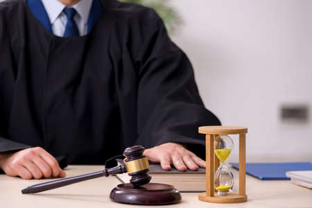 Young male judge in time management concept