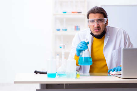 Young male chemist student preparing for examの写真素材