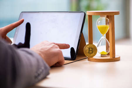 Young man earning money via Internet in time management concept