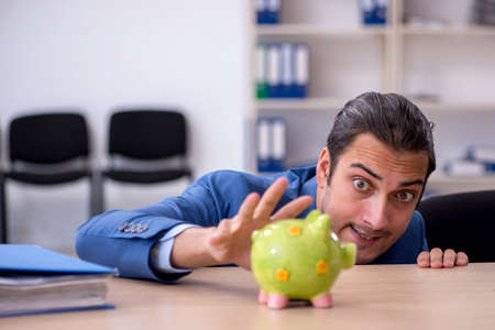 Young male employee in budget planning conceptの写真素材