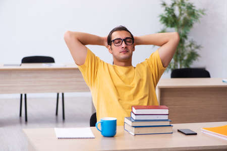 Young male student preparing for exams in the classroomの写真素材