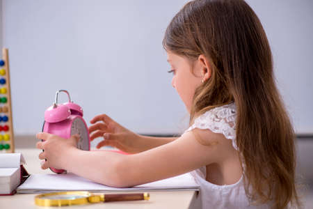 Small girl preparing for exams at home