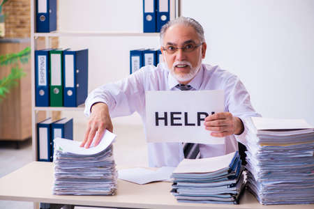 Old male employee unhappy with excessive work in the office