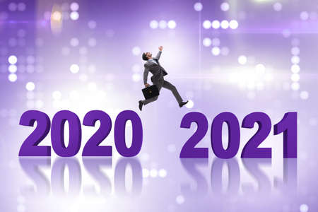 Businessman jumping from the year 2020 to 2021