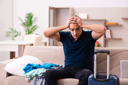 Young man preparing for journey at homeの写真素材