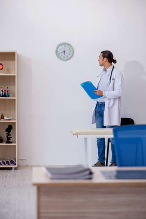 Young male doctor working in the clinicの写真素材