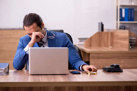 Young male employee sitting at workplaceの写真素材