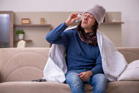 Young man suffering at homeの写真素材