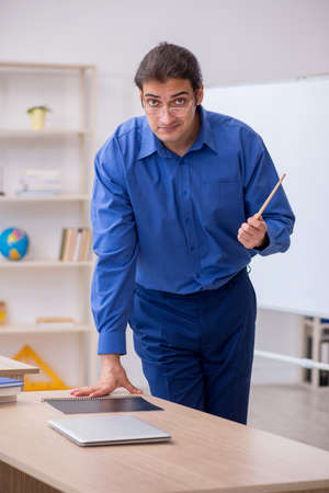 Young male teacher in front of white boardの写真素材