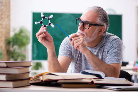 Old male physicist student in the classroomの写真素材