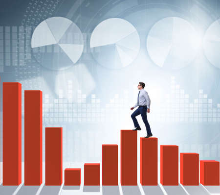Businessman going up the bar chart in growth concept