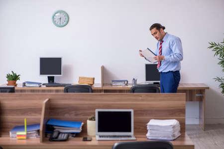 Young male employee in industrial espionage conceptの写真素材