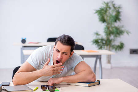 Young male student preparing for exam in the classroomの写真素材