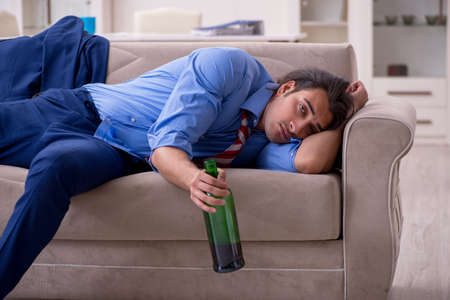 Young male employee being fired from his work at homeの写真素材