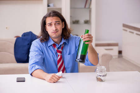 Young male employee being fired from his work at homeの写真素材