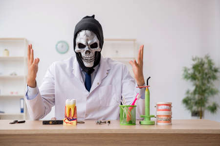 Devil doctor stomatologist working in the clinicの写真素材