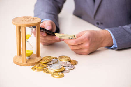 Young man earning money via Internet in time management concept