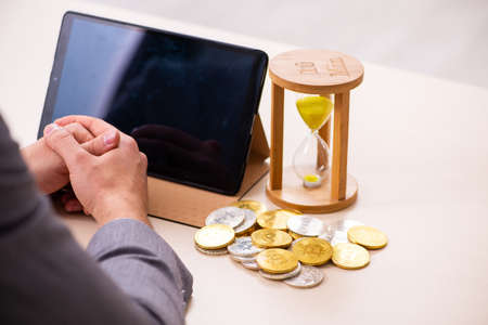 Young man earning money via Internet in time management conceptの写真素材