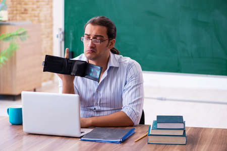 Young male teacher in remuneration concept
