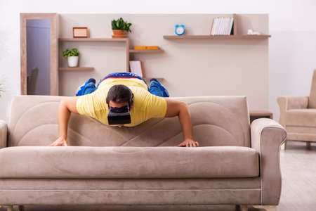 Young man student with virtual glasses at homeの写真素材