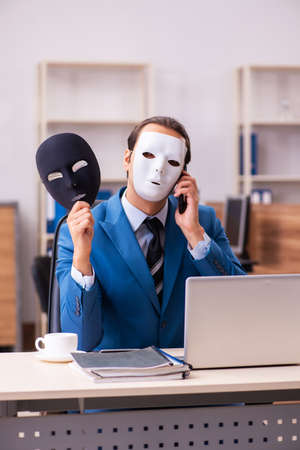 Young male employee wearing masks in the officeの写真素材