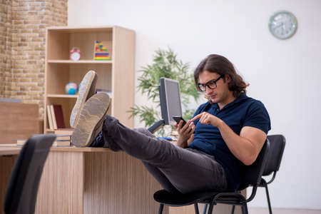 Young male student having break during exam preparation