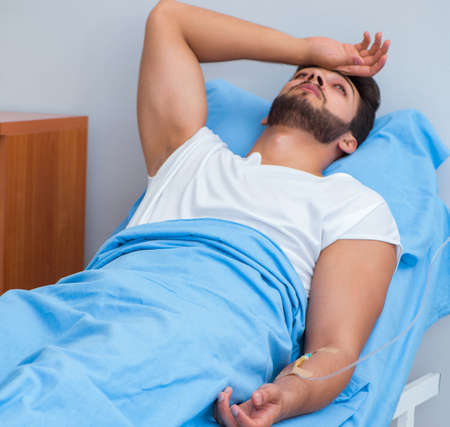 Woman doctor examining male patient in hospital