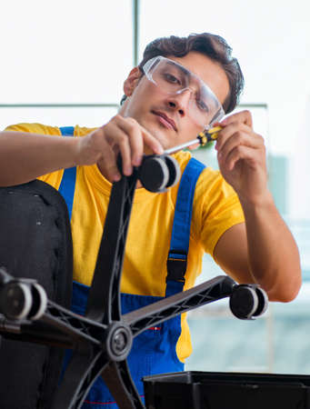 Furniture repairman working on repairing the chairの写真素材