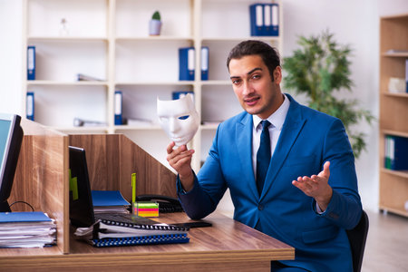Young male employee wearing mask in the officeの写真素材