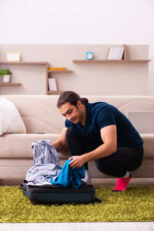 Young man preparing for journey at homeの写真素材