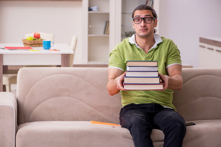 Young male student preparing for exams at homeの写真素材