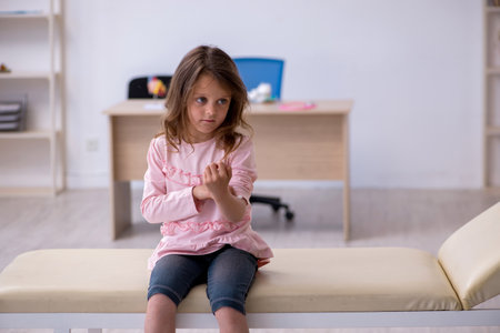 Small girl holding syringe waiting for doctor in the clinicの写真素材