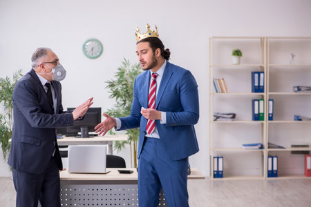 Two employees at workplace during pandemicの写真素材