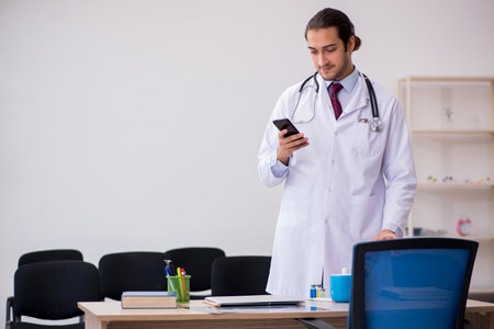 Young male doctor giving seminar in the classroomの写真素材