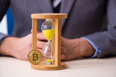 Young man earning money via Internet in time management conceptの写真素材