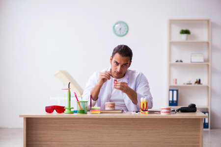 Young male dentist working in the clinicの写真素材