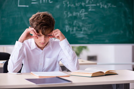 Schoolboy preparing for exams in the classroomの写真素材
