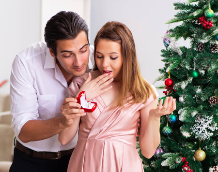 Man making marriage proposal at christmas dayの写真素材