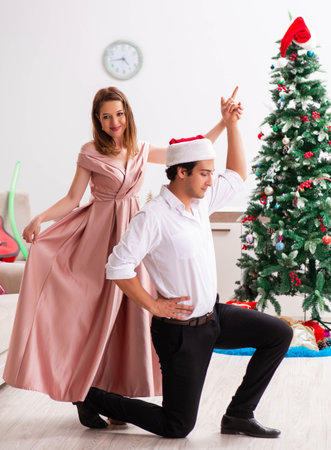 Young pair celebrating christmas at homeの写真素材