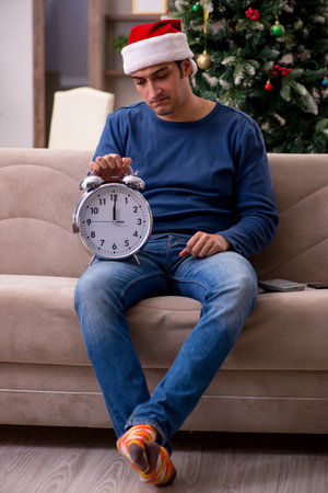 Young man celebrating Christmas alone at home