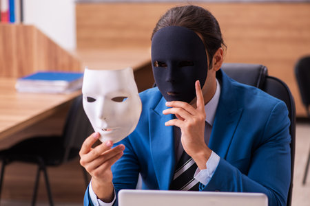 Young male employee wearing masks in the officeの写真素材