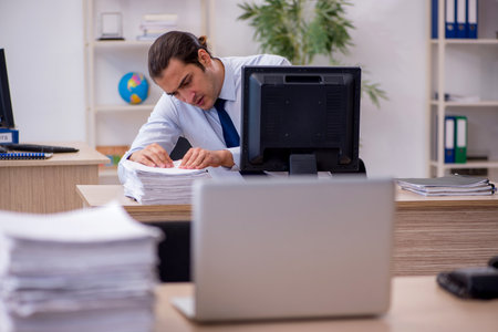 Young male employee sitting in the officeの写真素材