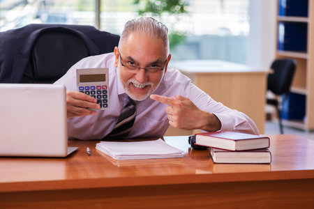 Old businessman employee working in the officeの写真素材
