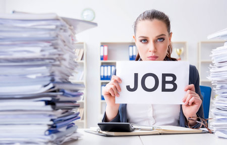 Businesswoman not coping with workload and resigningの写真素材