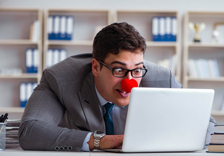 Clown businessman working in the officeの写真素材