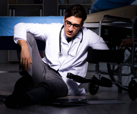 Doctor working night shift in hospital after long hoursの写真素材