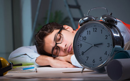 Sleeping architect after late long hoursの写真素材
