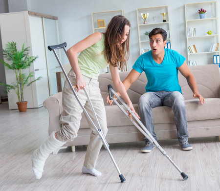 Husband man supporting injured wifeの写真素材