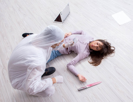 Forensic investigator at the crime scene investigating woman murの写真素材