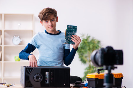 Teenager computer repairman recording video for his blogの写真素材